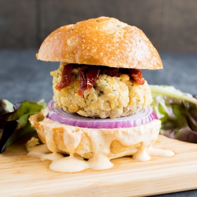 A front close up view of Tempeh Parmesan Burger with Habanero Dip