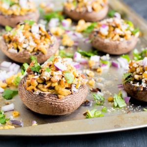 Vegan Cheese and Tempeh Stuffed Portobello Mushrooms are shown in a cookie sheet just out of oven