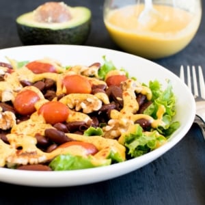 A 45 degree angle view of kidney beans salad wit cheesy avocado dressing