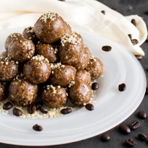 A stack of 4 ingredient coffee hemp energy bites on a white plate