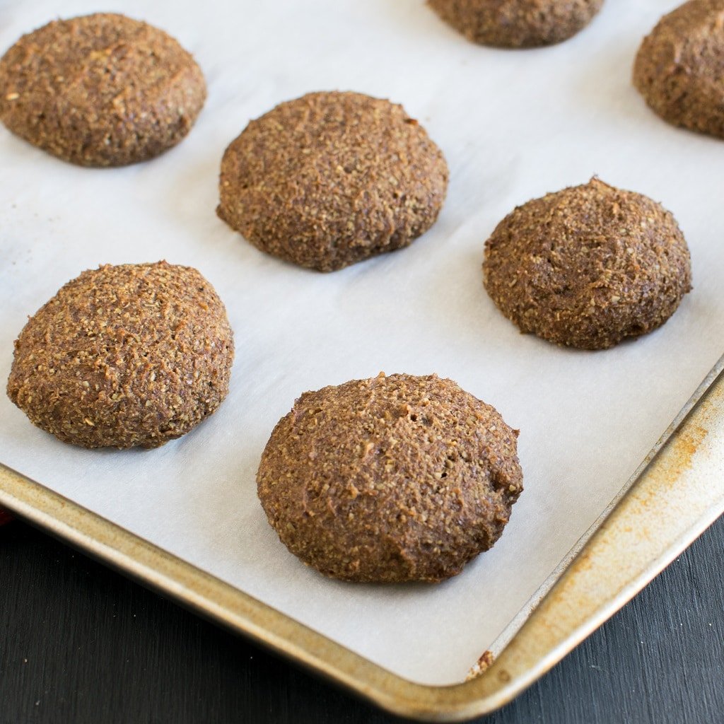 Coffee Flax Cookies are displayed on a lined cookie sheet fresh out of the oven and without any frosting and decoration