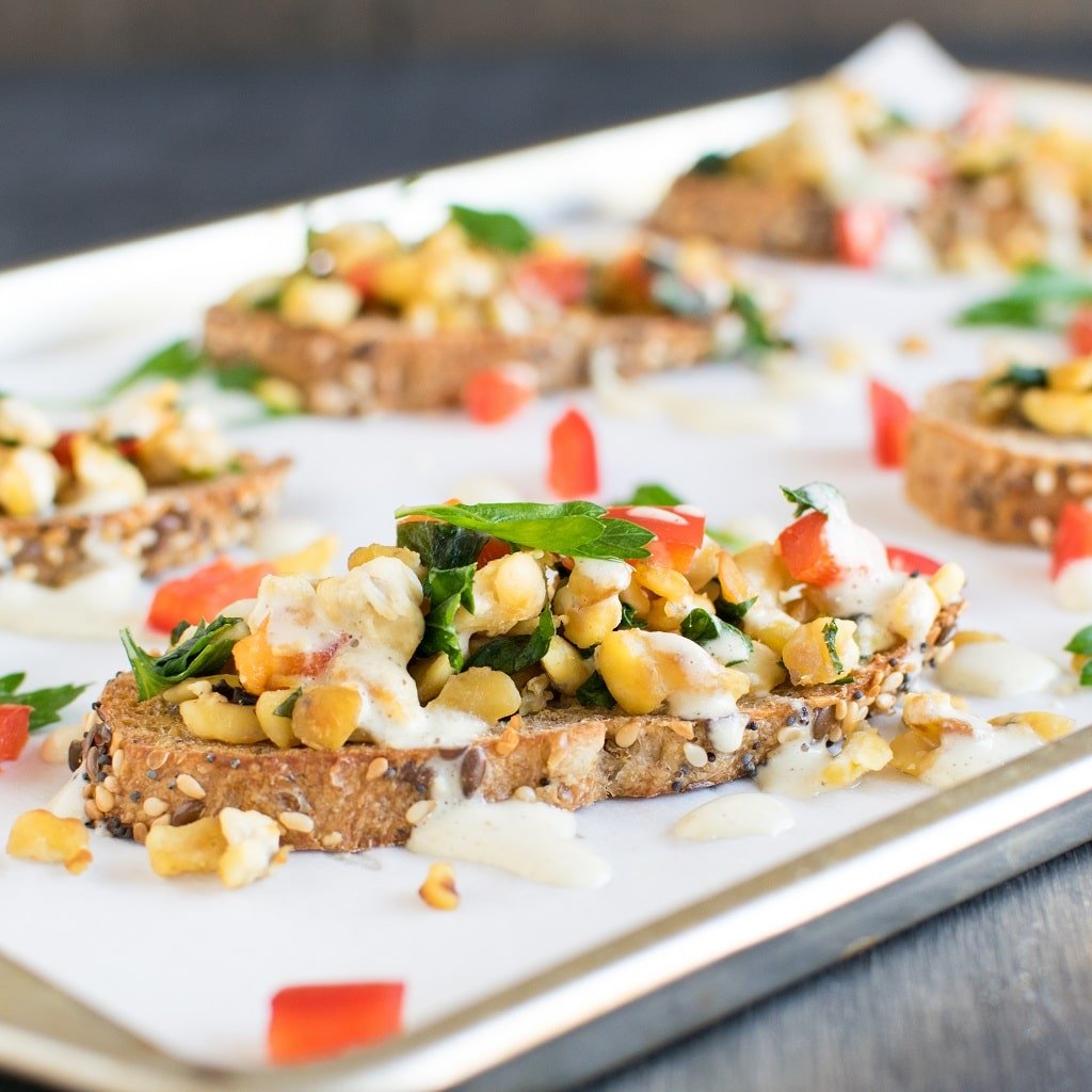 A closer front angle view of Herbed Cashew Cream Tempeh Crostini 