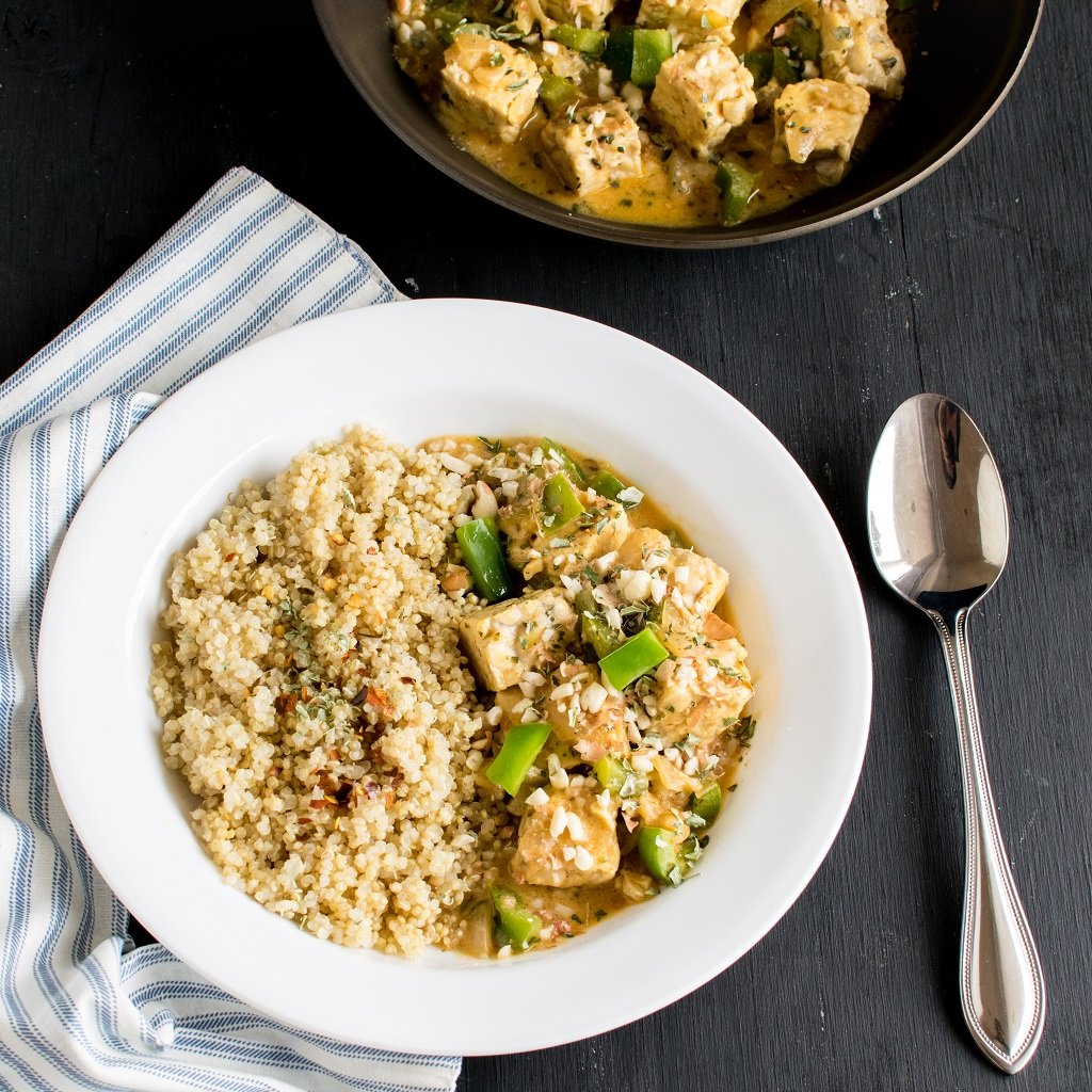 One Pot Peanut Butter Tempeh Curry is shown in a white bowl along with quinoa n the side | kiipfit.com