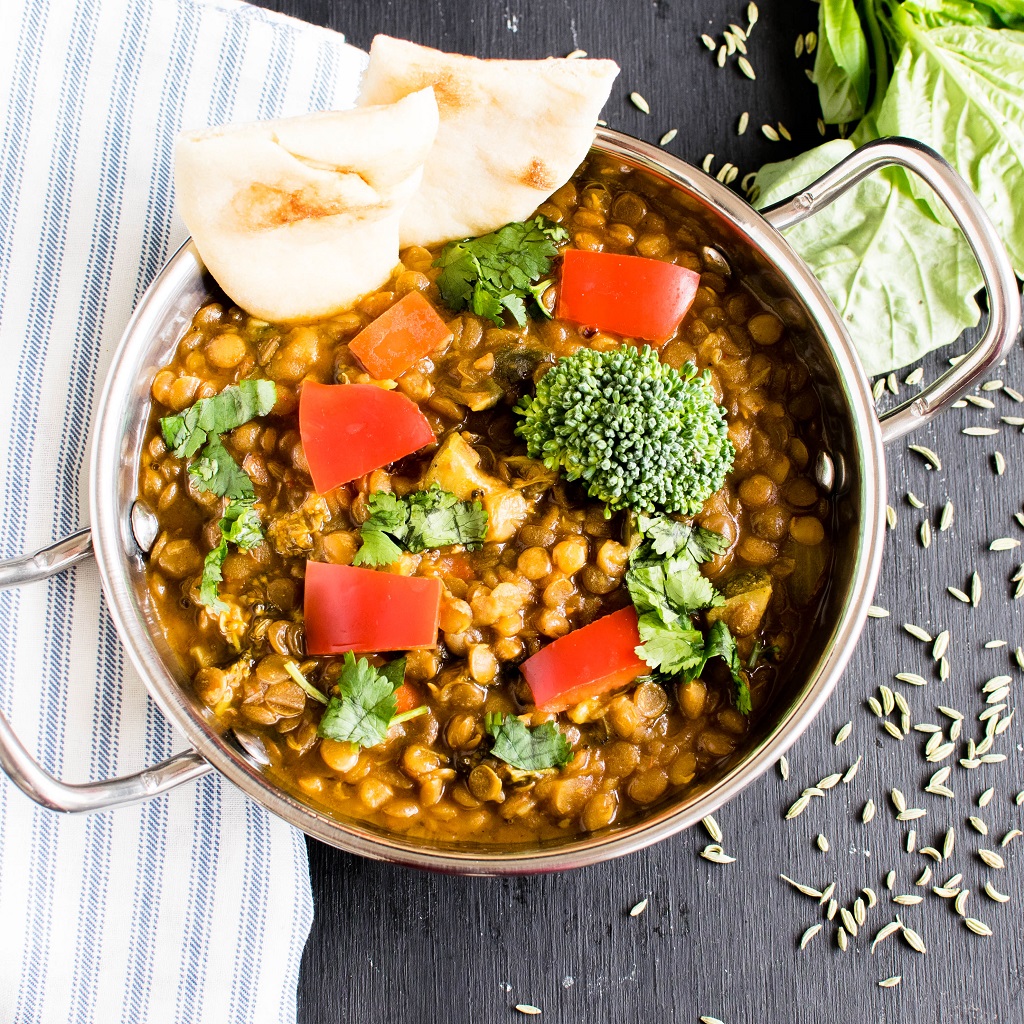 Instant Pot Herbed Masala Lentil Curry is shown in an indian utensil along with naan to show how the pairing of two food items | kiipfit.com