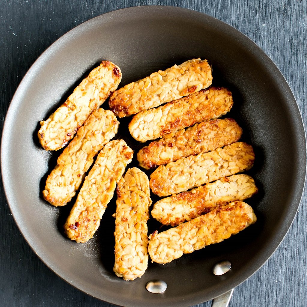 Marinated tempeh being cooked on a nonstick pan | kiipfit.com