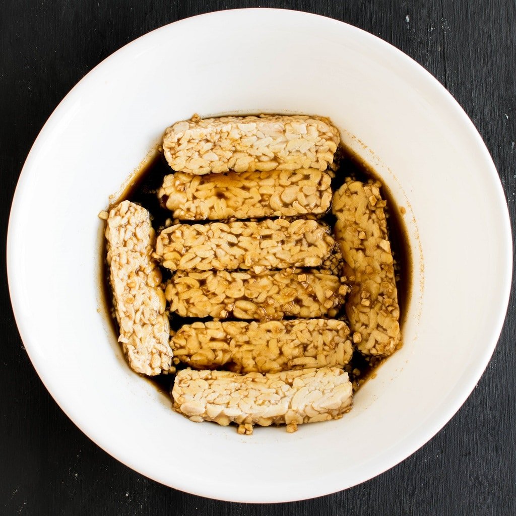 Tempeh is shown in the process of marinating | kiipfit.com
