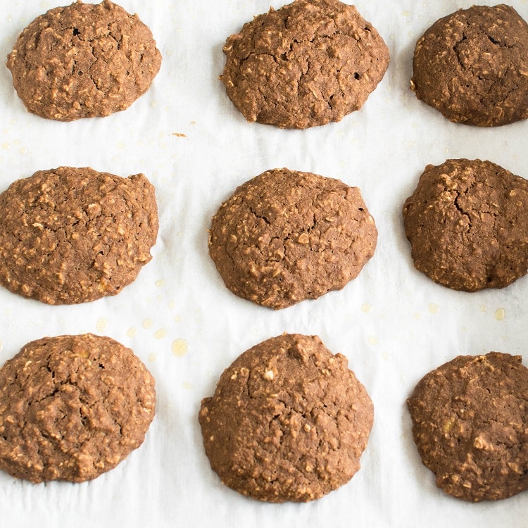 Vegan Mocha Oatmeal Cookies are shown on a cookie sheet fresh out of the oven. 