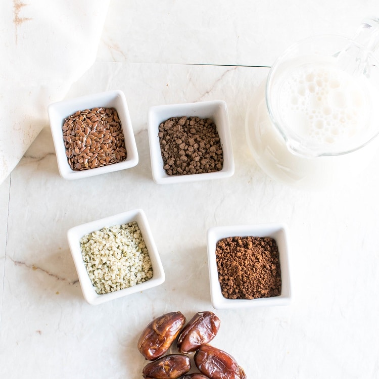 All the ingredients of Chocolate Mocha protein Smoothie is displayed on a white board in this image