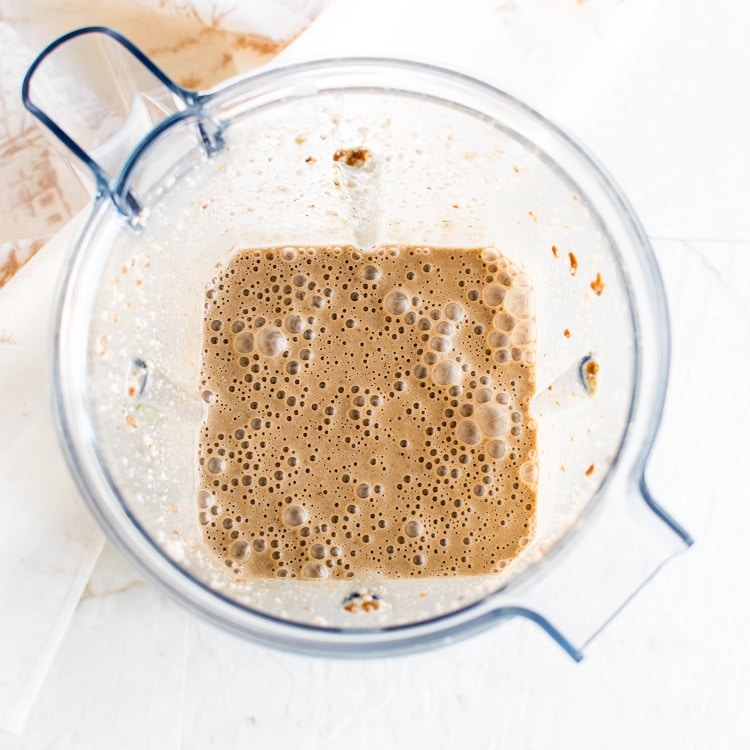 Blended Chocolate Mocha Protein Smoothie is shown in a blender