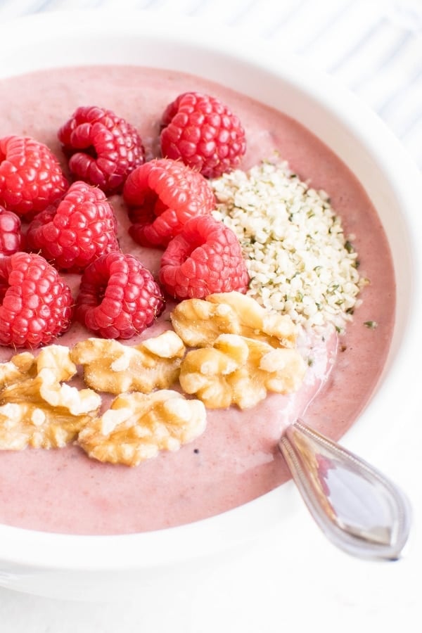 A 45 degree angle view of raspberry smoothie bowl.
