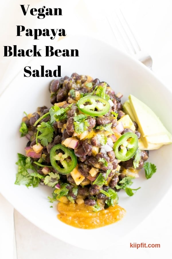 Top view of Vegan Black Bean Salad with sliced avocado and dressing on the side 