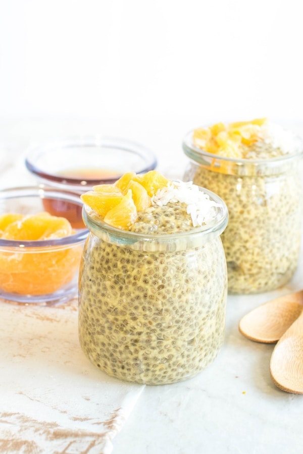 a front view of jars filled with orange coconut breakfast chia pudding.