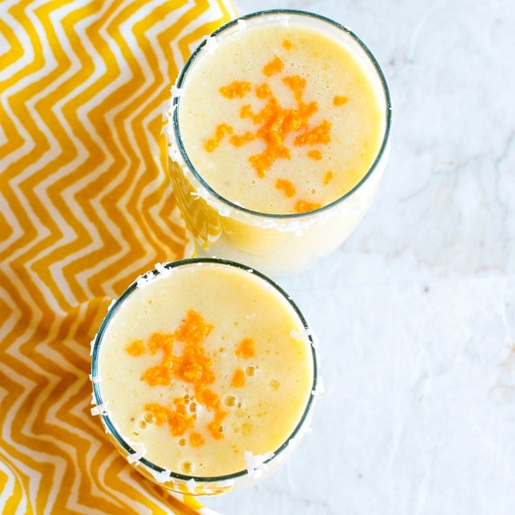 A top view of Tropical Coconut Turmeric Smoothie in the serving glasses