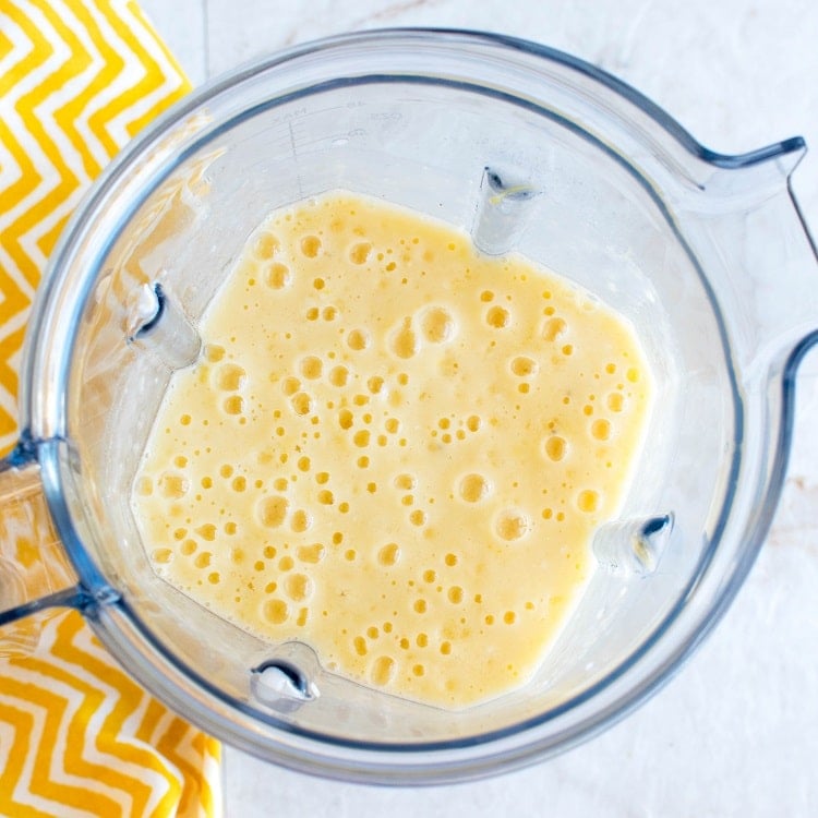 Blended Tropical Coconut Turmeric Smoothie in a blender