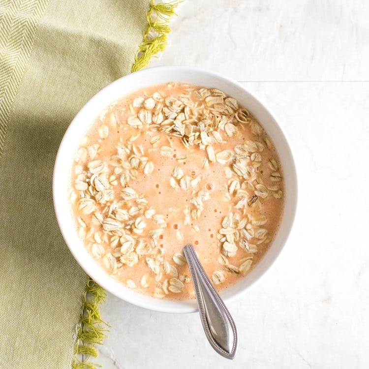 Oats stirred in carrot cake smoothie