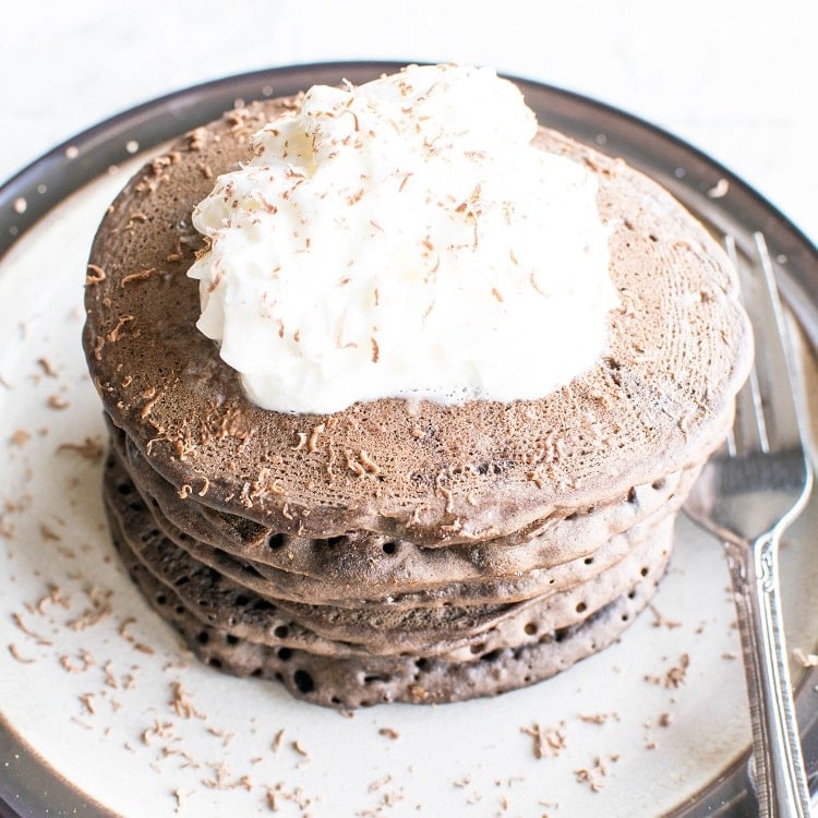 a 45 degree angle view of stacked vegan buckwheat pancakes.