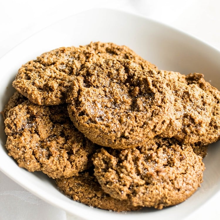 A bowl loaded with almond flour vegan ginger cookies.