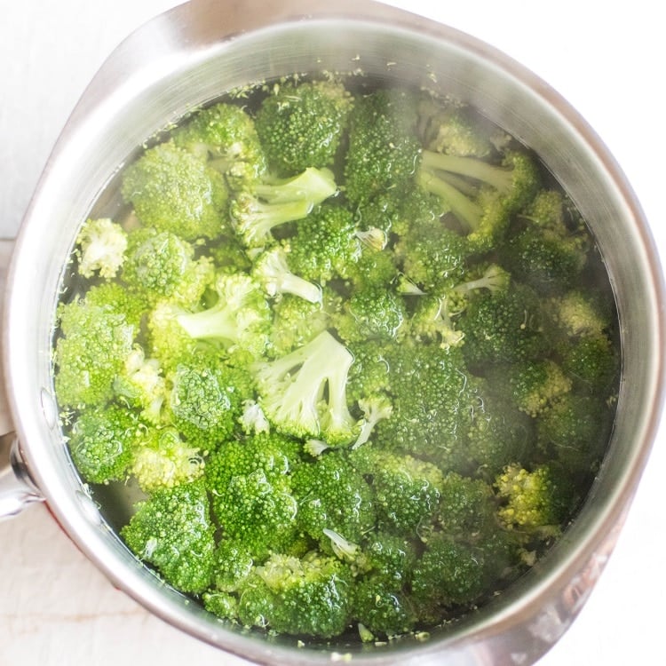 broccoli florets in boiling water to be blanched.