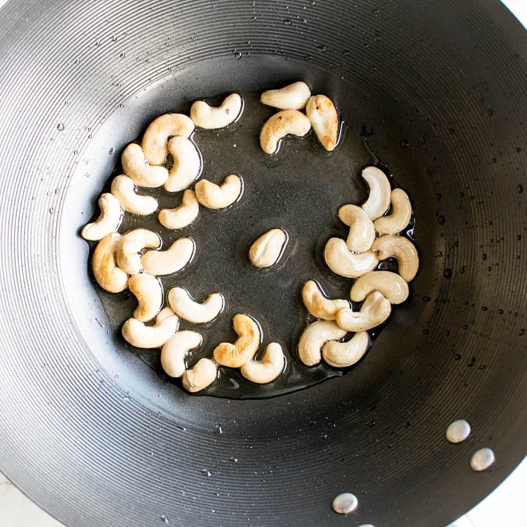 Sauteed cashew nuts in a wok