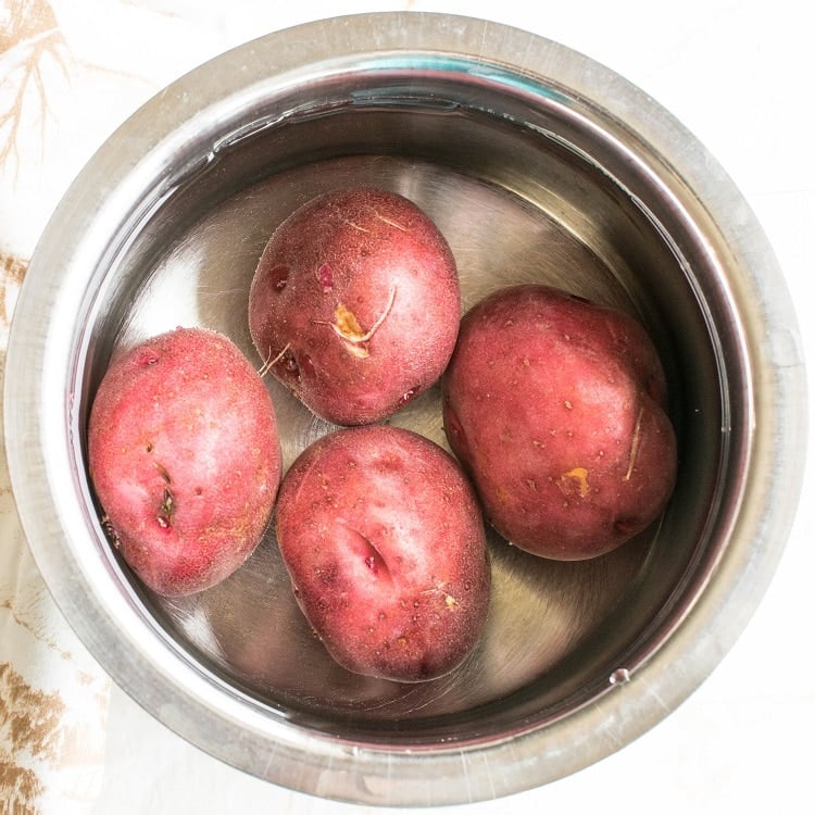 red potatoes boiling in a saucepan