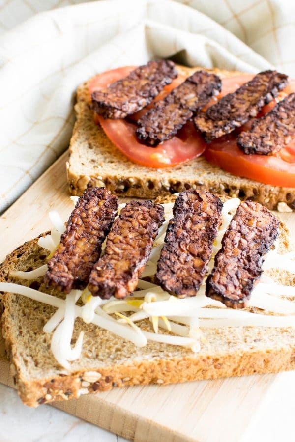 A 45 degree angle view of tempeh Bacon in sandwich