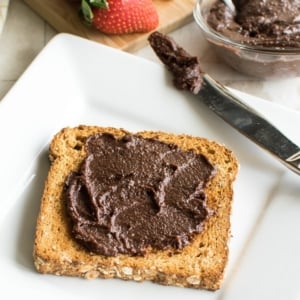 A 45 degree angle view of a toast spread with vegan nutella