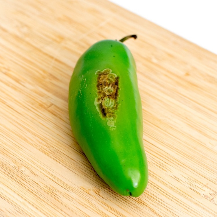 roasted jalapeno on a wooden board