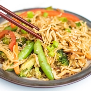 chop sticks in action to pick almond butter vegetable stir fry noodles