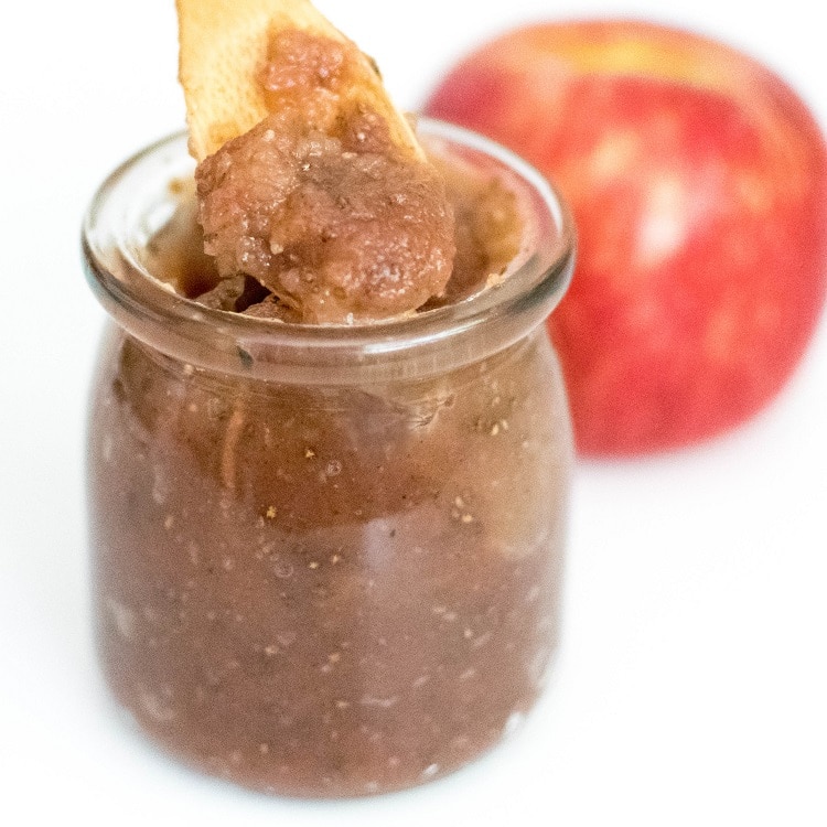 a spoon picking up apple jam recipe from its jar