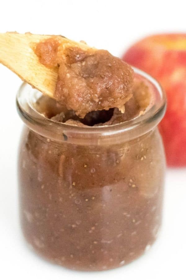 A close up view of a spoon with apple jam recipe