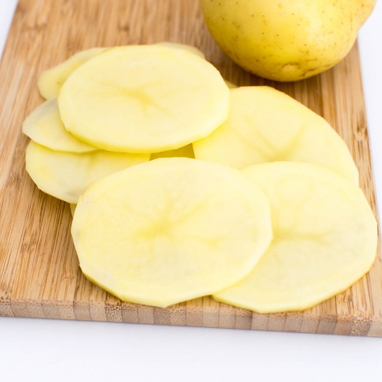 sliced potatoes on a wooden board