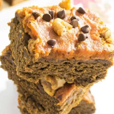 A 45 degree angle view of stacked pumpkin brownies.