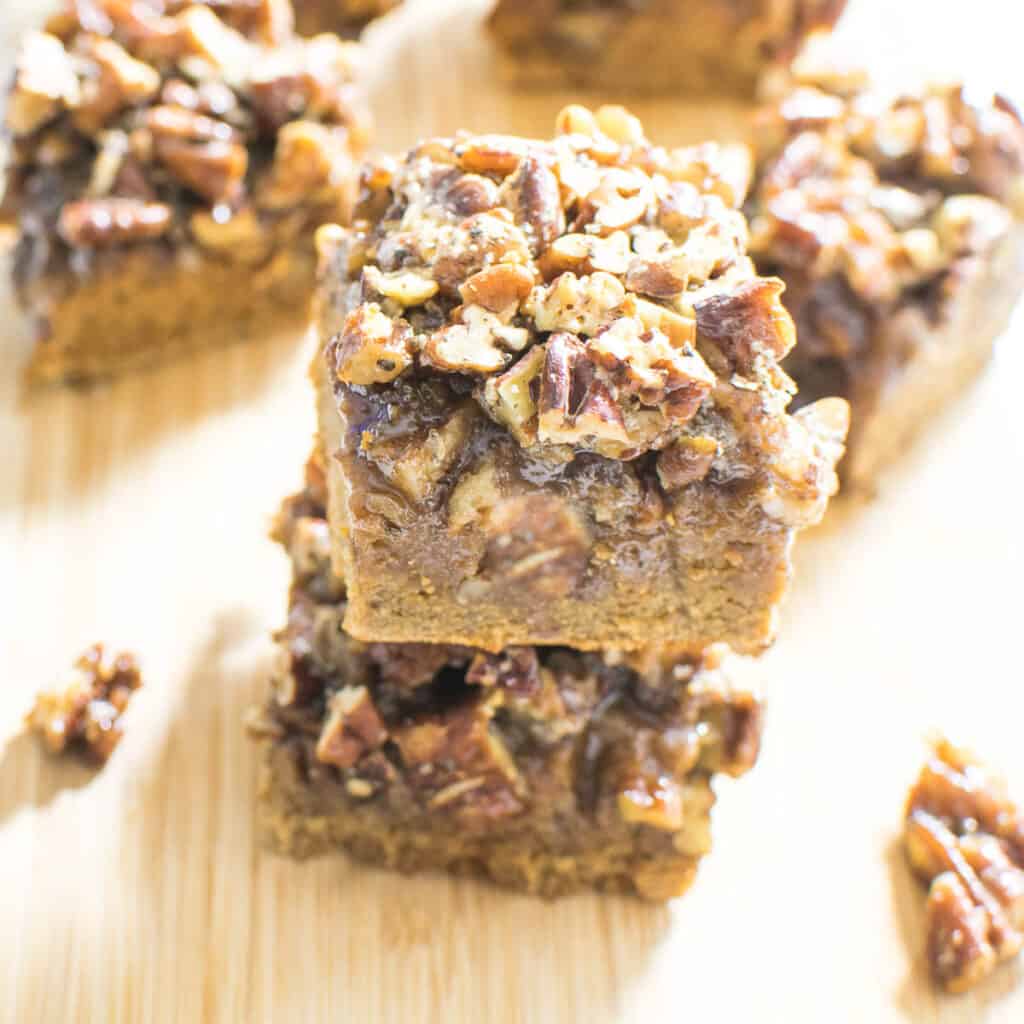 A close up view of stacked pecan pie bars