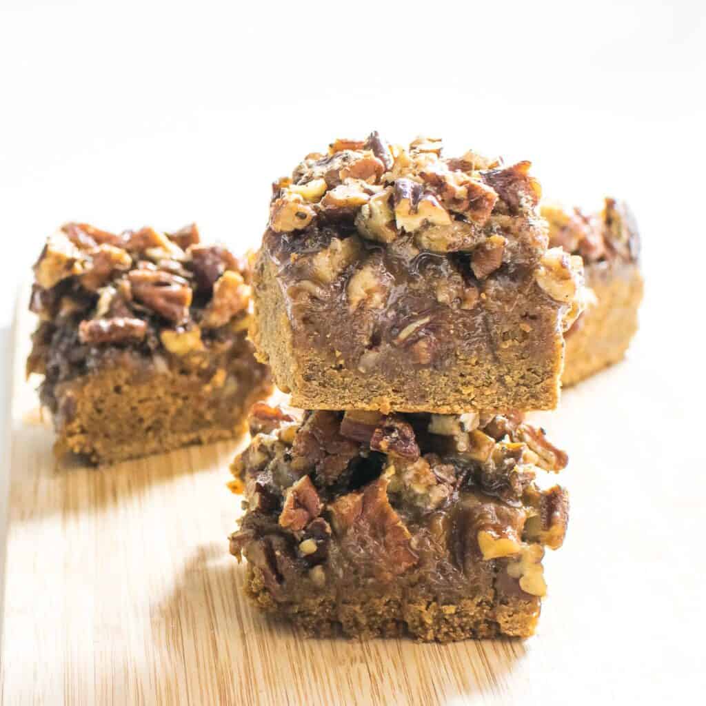 A front view of stacked pecan pie bars squares.