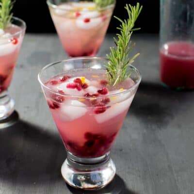 Serving glasses filled with Sparkling Pomegranate Coconut Mocktail