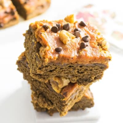 A 45 degree angle view of stacked pumpkin brownies.