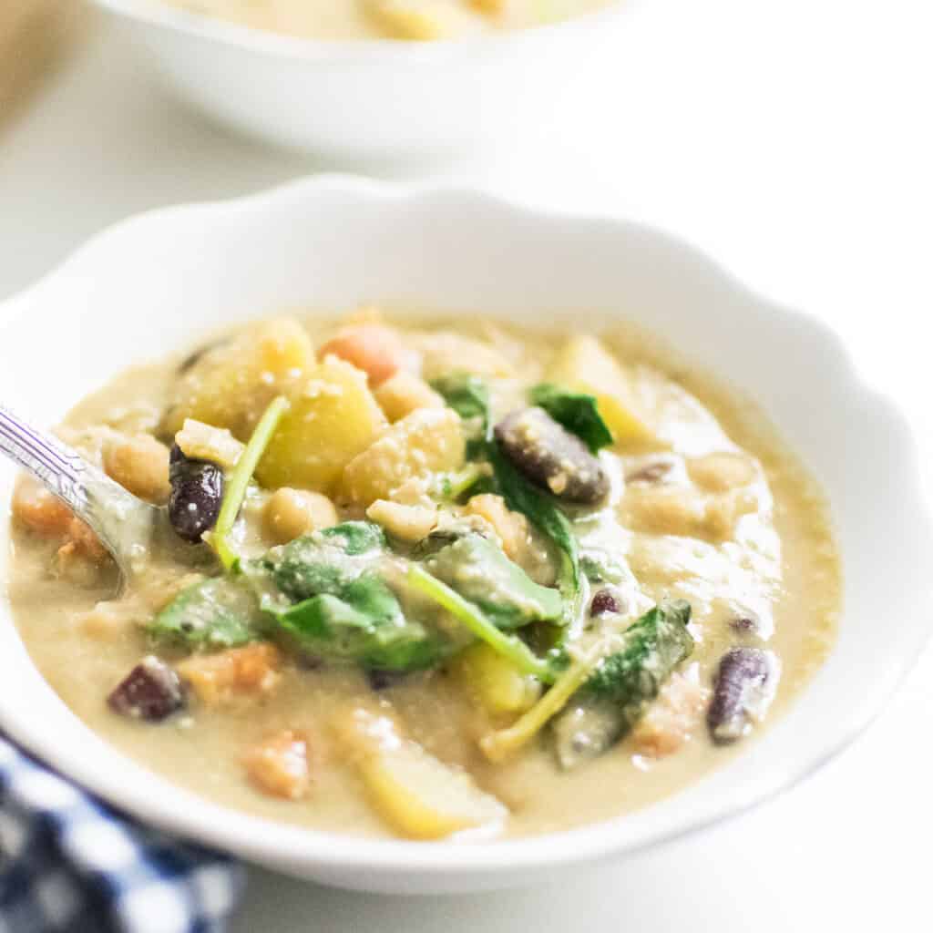 A spoon picking up instant pot zuppa toscana.