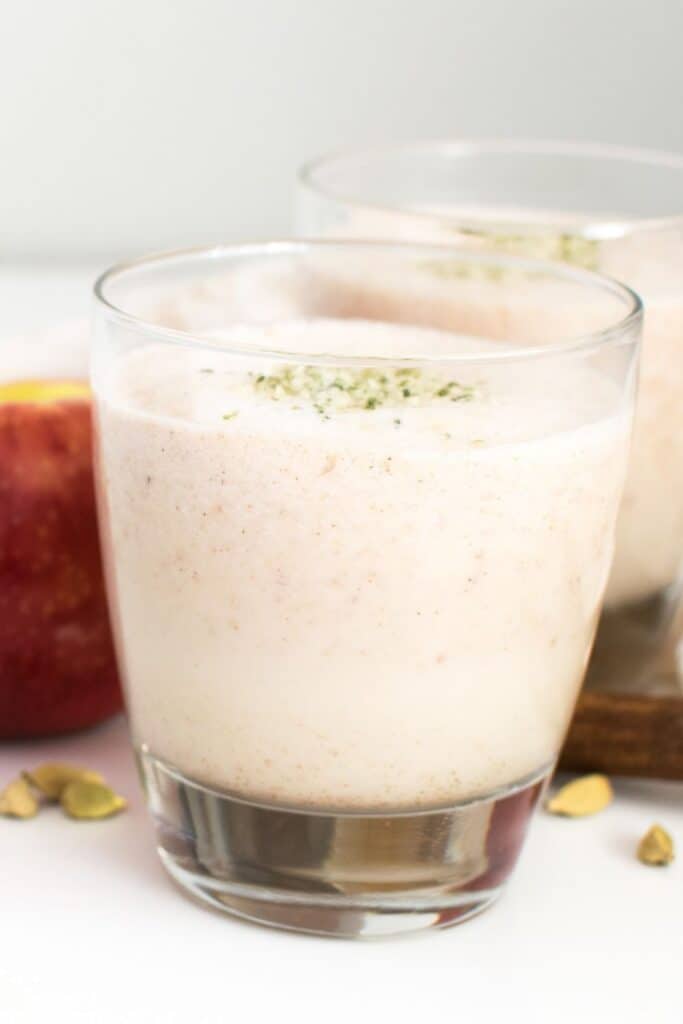 full view of apple smoothie in a serving glass.
