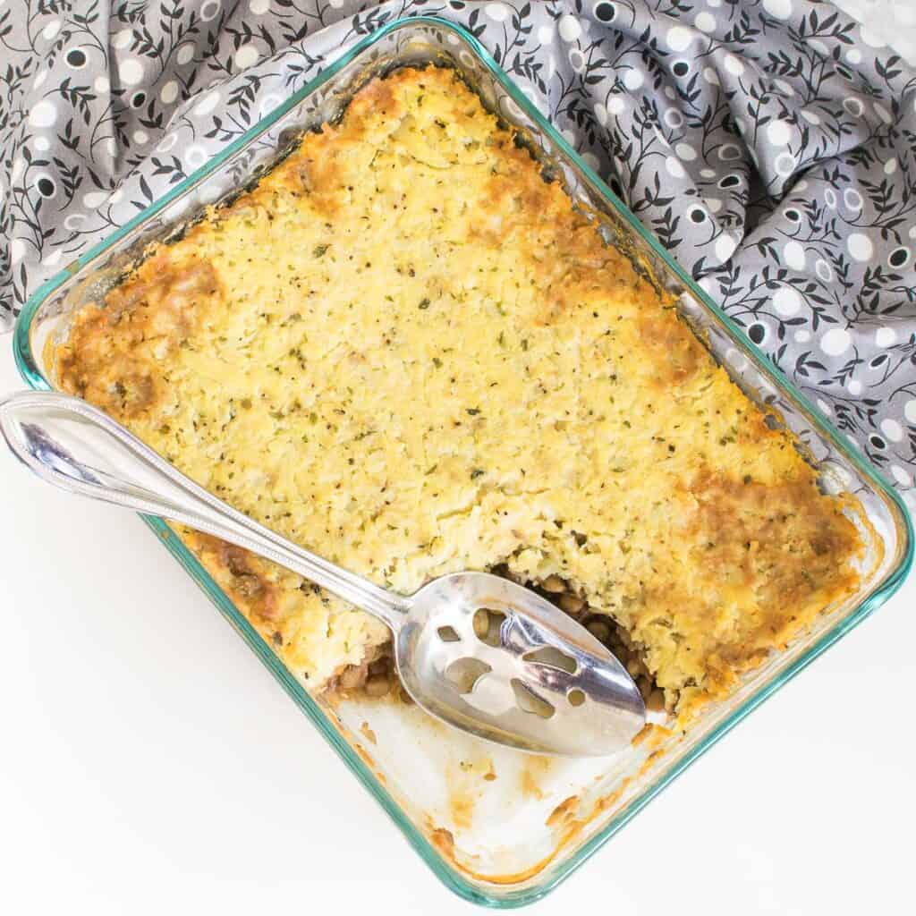 half scooped lentil shepherd's pie from the baking dish.