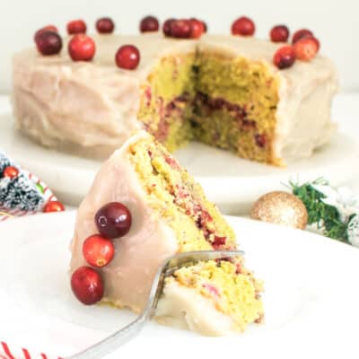 a fork digging through a slice of cranberry cake.