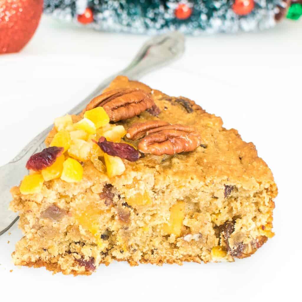 a close up view of a slice of Christmas fruit cake.