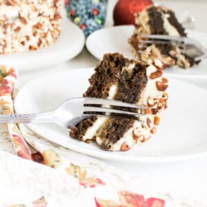 a fork slicing through a piece of gingerbread cake.
