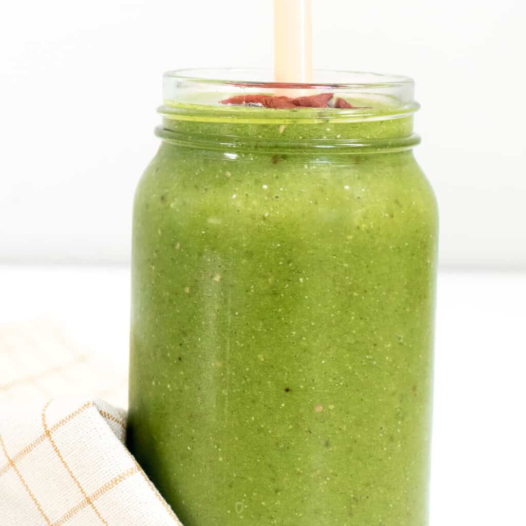 a tall glass with kale smoothie.
