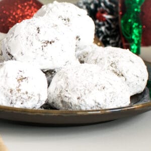 a front view of stacked walnut snowball cookies (vegan).