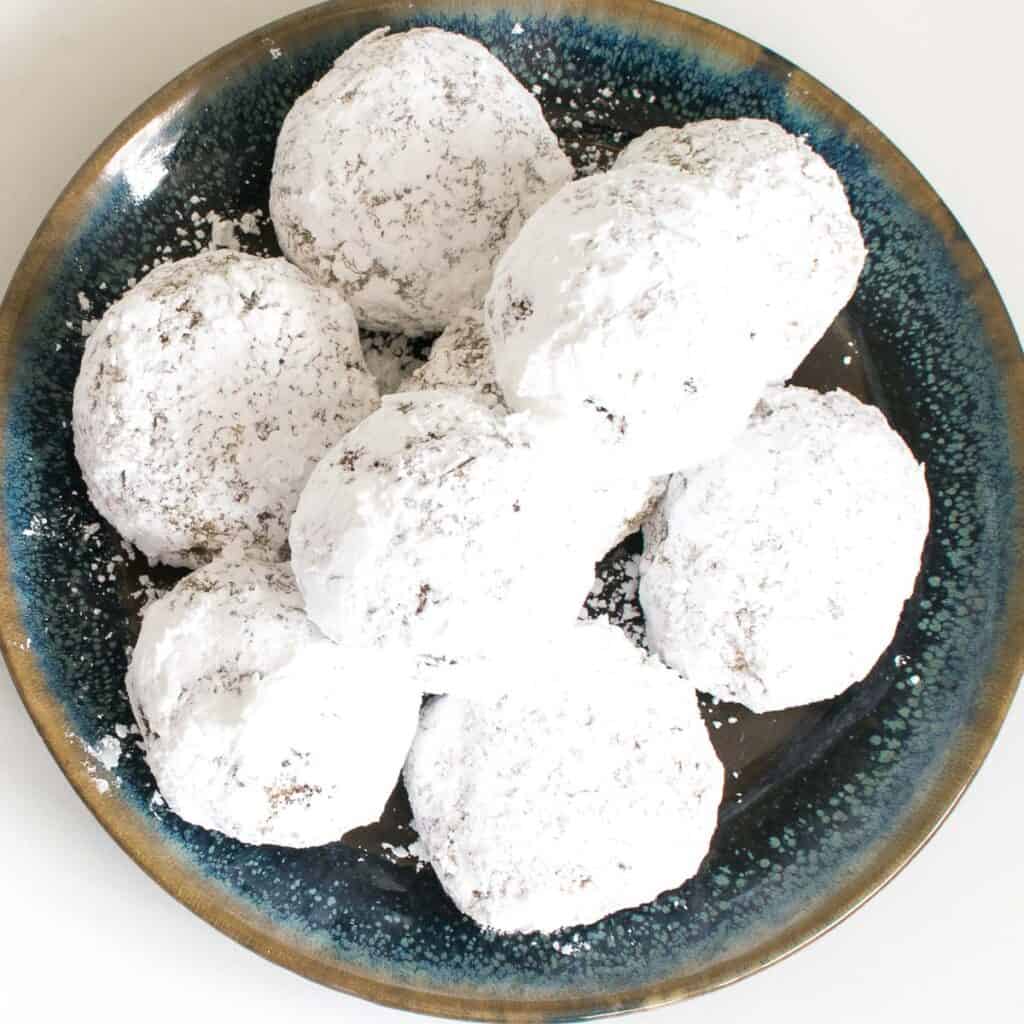 top view of a plate filled with walnut snowball cookies (vegan).