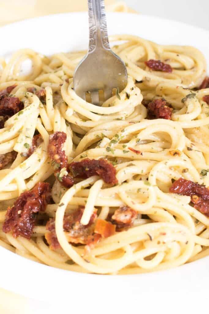 a fork rolling in vegan carbonara.