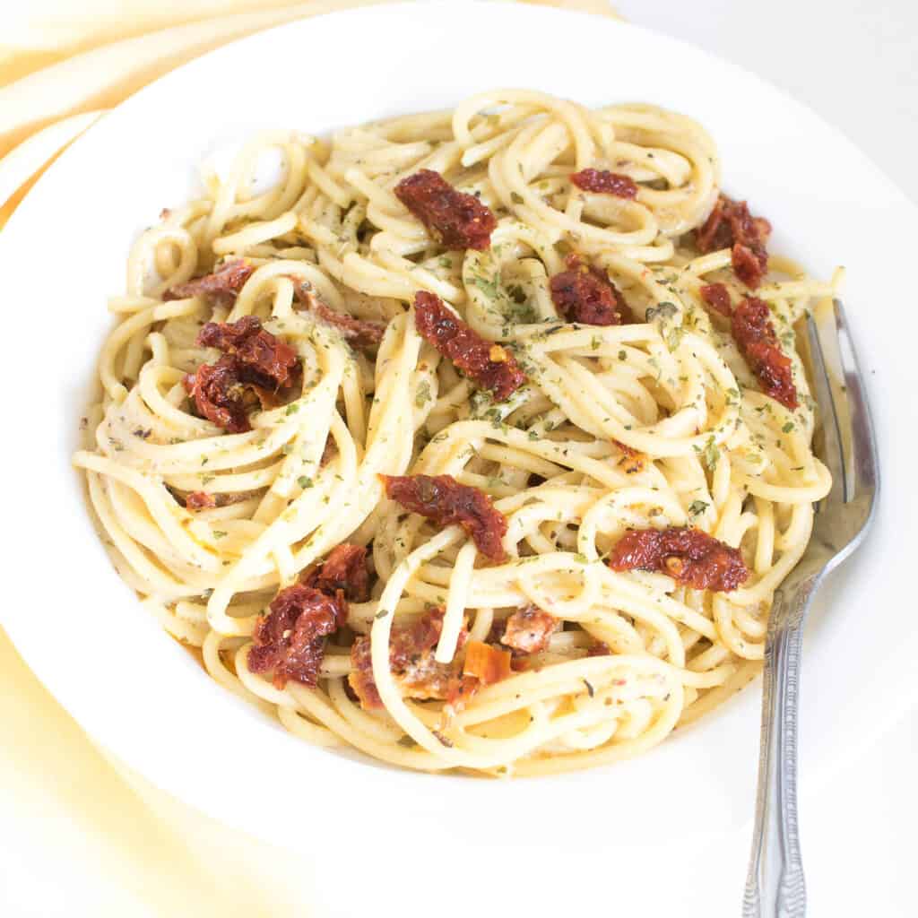 a 45 degree angle view of served vegan carbonara.