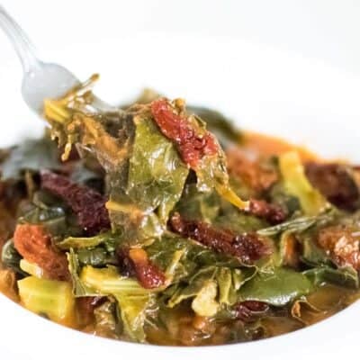 a fork scooping out vegan collard greens