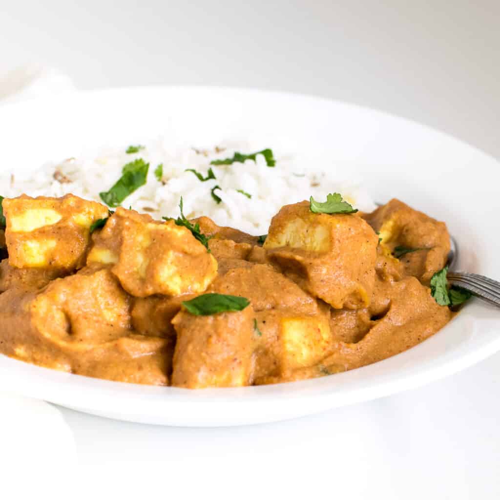 a front view of tofu tikka masala in a serving plate.