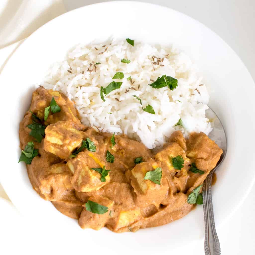 top view of tofu tikka masala served with rice. 